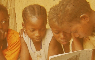 woman shows book to children