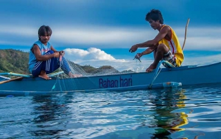 Two men fishing in canoe