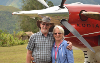 Andrew and Cathy standing in front of a Kodiak plane