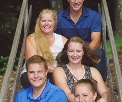 family of 5 sitting on wooden steps