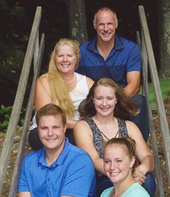 family of 5 sitting on wooden steps