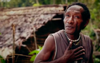 Papuan man emoting by tapping his chest