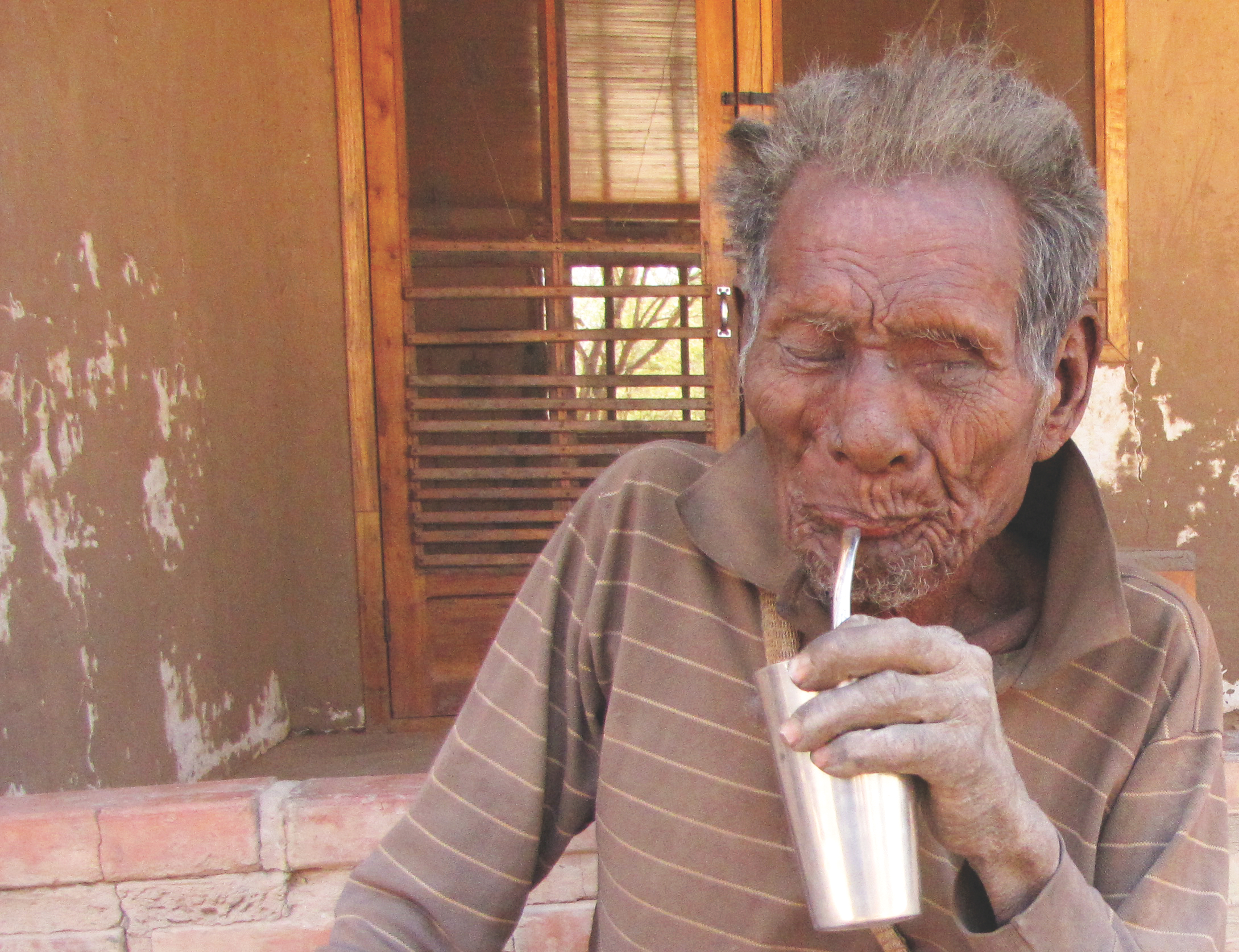 Manjui man drinking Terere