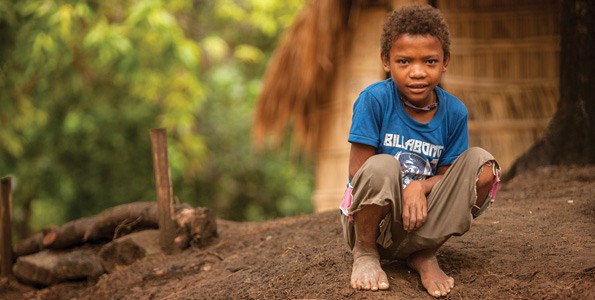 Young boy crouching on ground