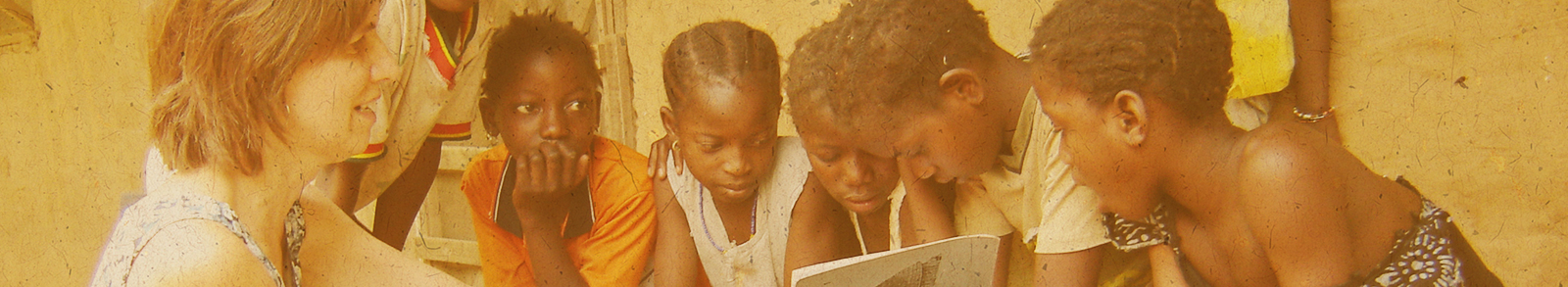 women teaching african children