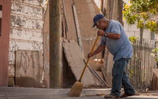 Man sweeping the sidewalk