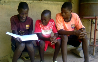 Budik boys study one of the books of the Bible.