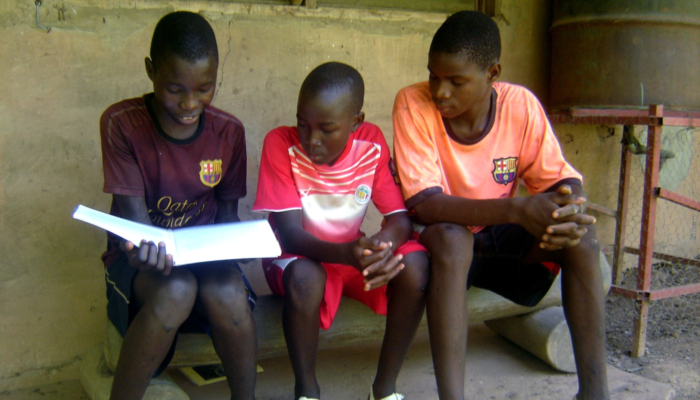 Budik boys study one of the books of the Bible.