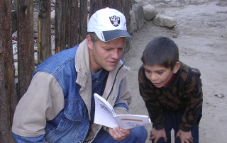 Young boy examines bible