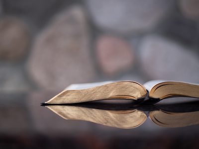 open Bible on a reflective table