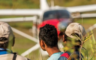 tribal men and plane