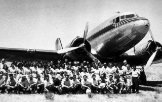 old plane with group of men