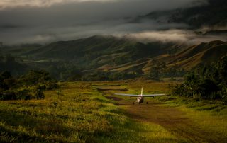 small plane on a mountainous runway