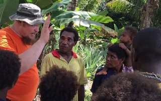 missionary with people from Papua New Guinea