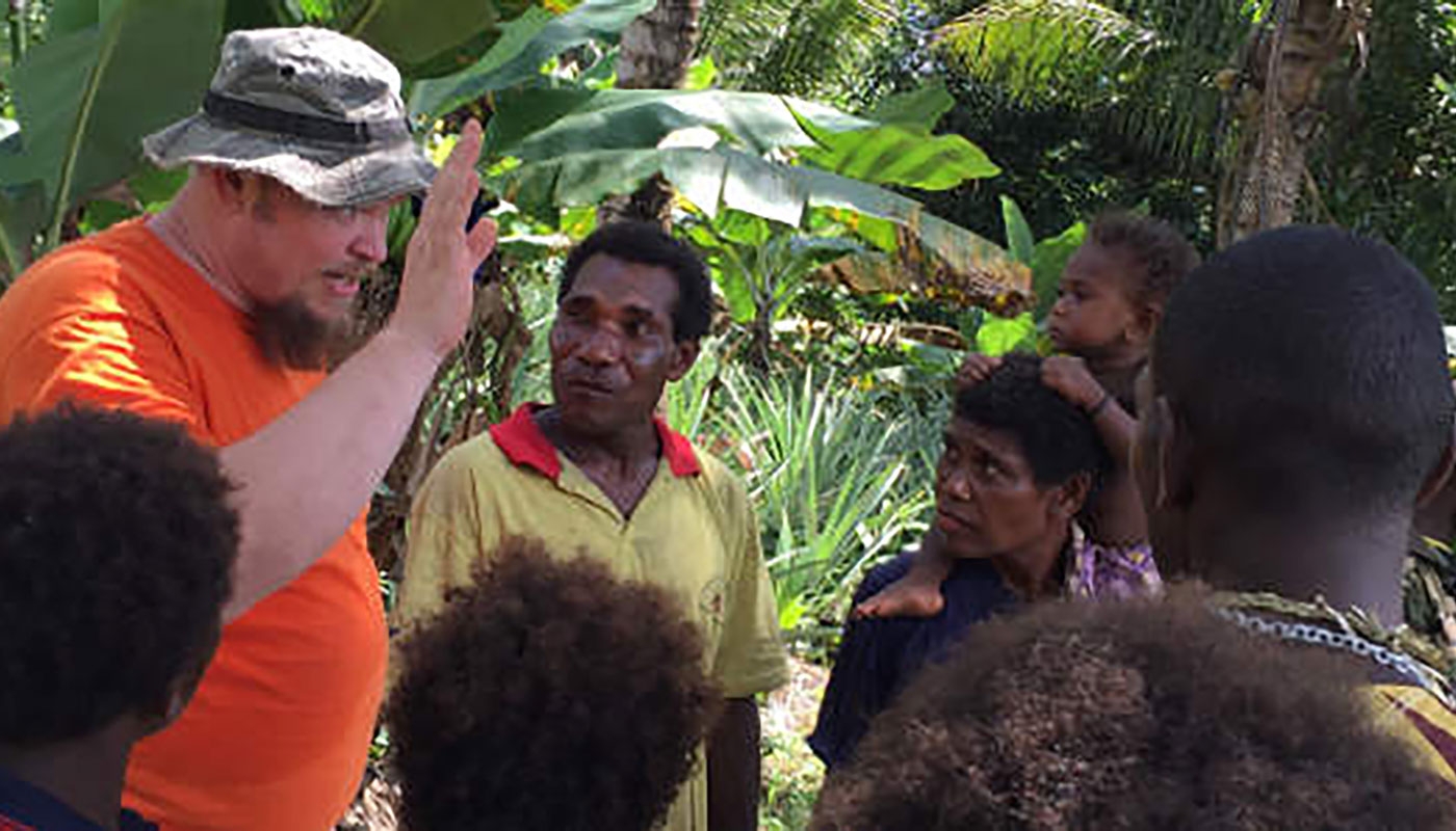 missionary with people from Papua New Guinea