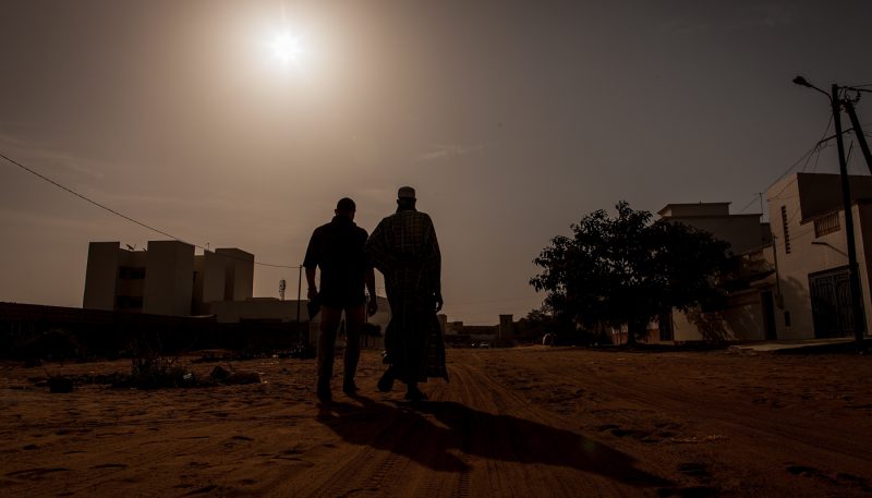 Silhouette of two men in Africa