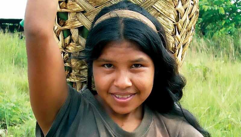 girl carrying basket on her head