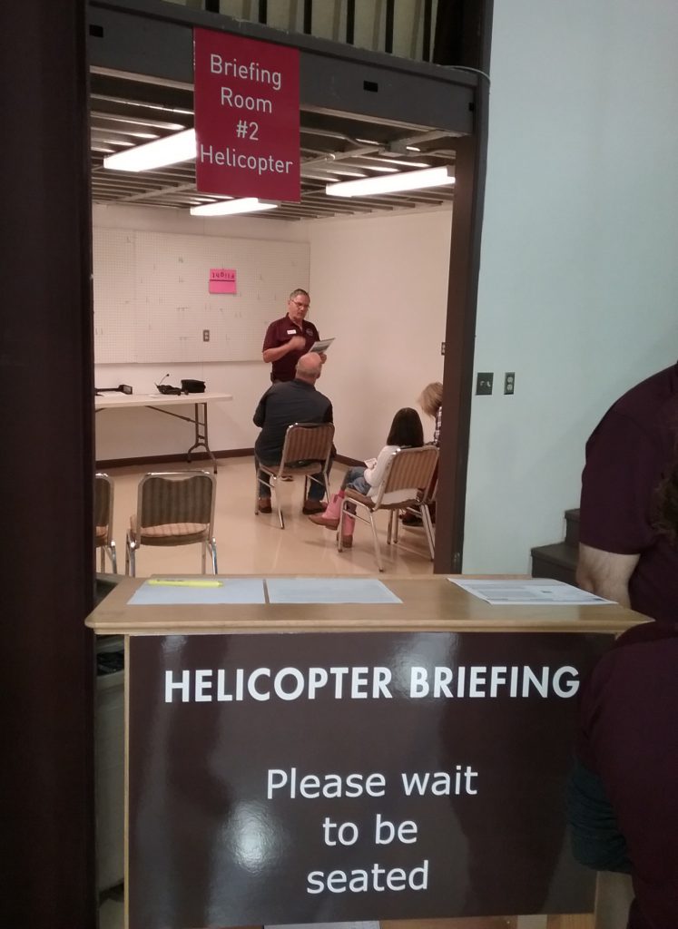 people being briefed before a helicopter flight