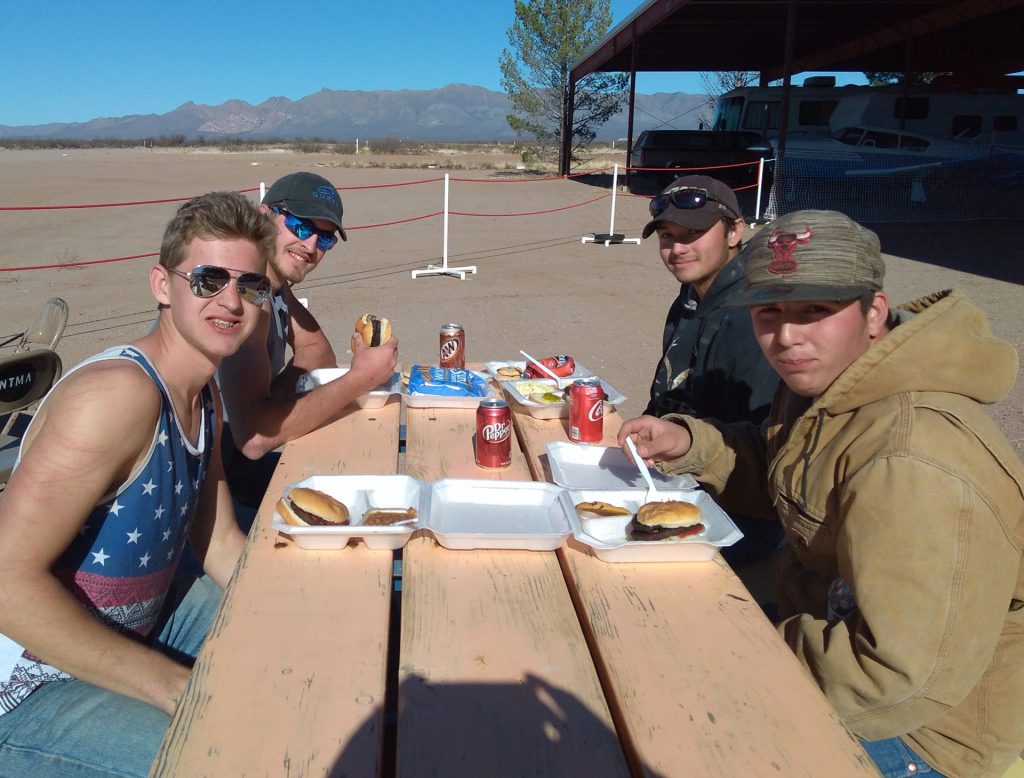 teen hikers enjoy their meal