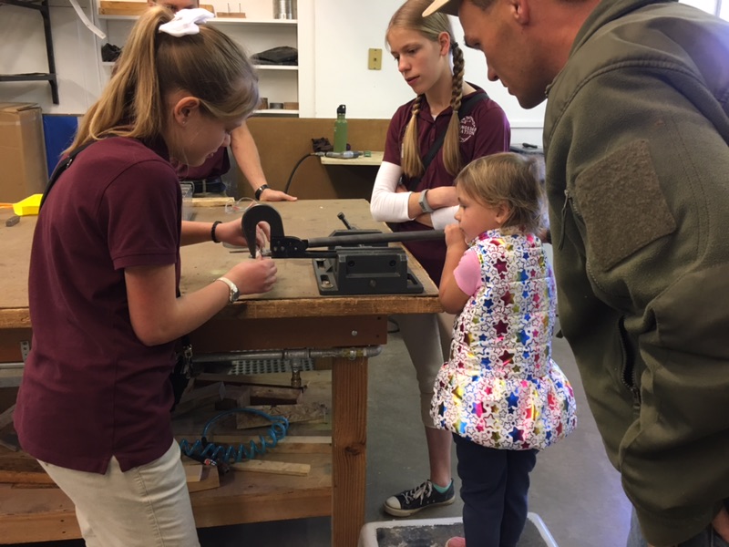 kids riveting a small metal plane