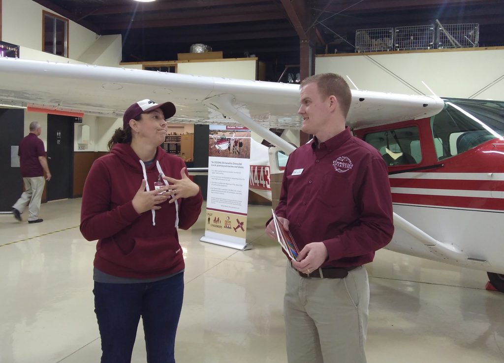 two people infront of a plane discuss training requirements to be a missionary aviator