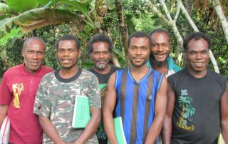 Papua New Guinea men with reading primers