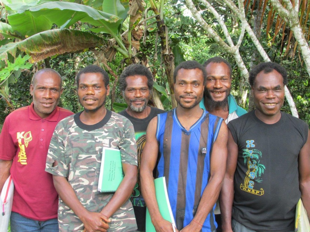 Papua New Guinea men with reading primers