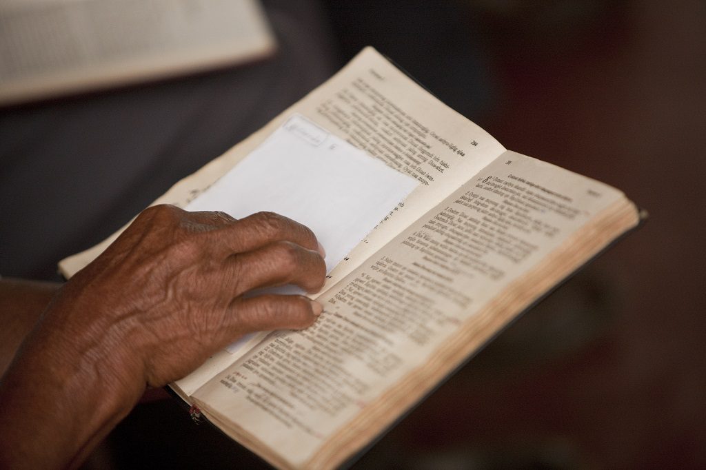 hand on open Bible