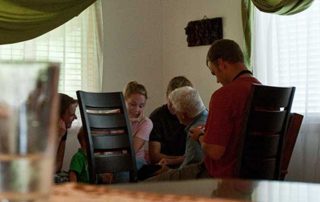 missionaries meeting in a house