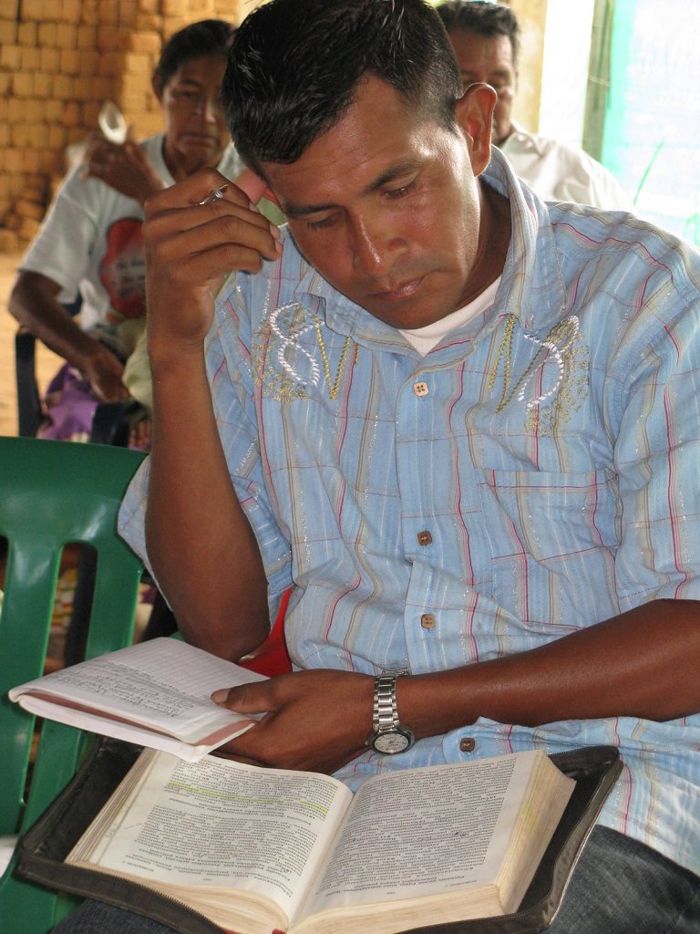 Guahibo man studying the Bible