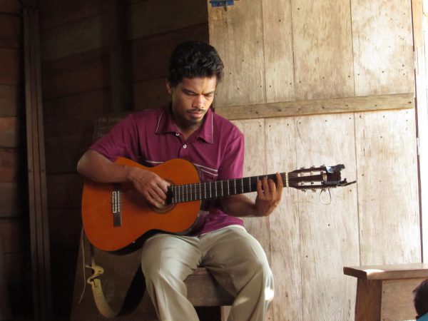 man playing a classical guitar