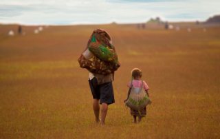 woman and child carrying goods in string bags