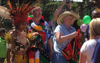 aged missionaries at a Bible dedication ceremony with their friends