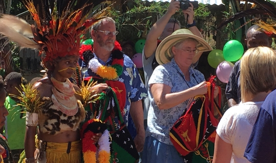 aged missionaries at a Bible dedication ceremony with their friends