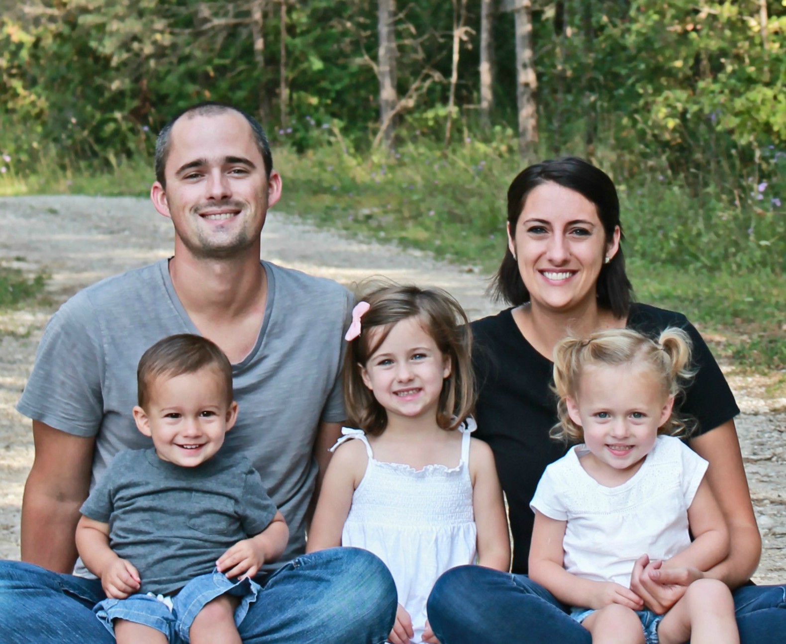 Shaiebly family sitting near the woods at Ethnos Canada