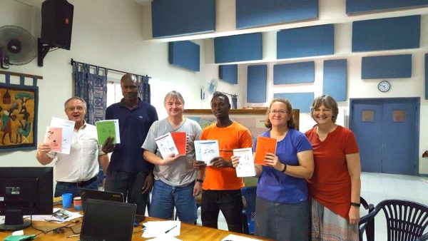 African literacy materials being shown off by missionaries and their friends