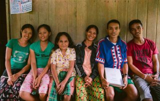 Filipino group sitting on a bench