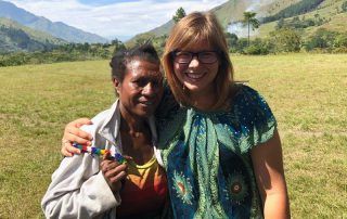 missionary woman standing on the airstrip with a Menyan woman