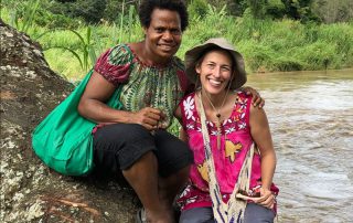 missionary woman with her Papua New Guinean friend by a river