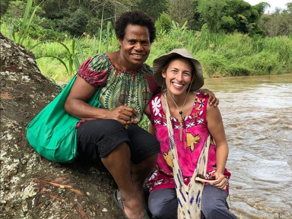 missionary woman with her Papua New Guinean friend by a river