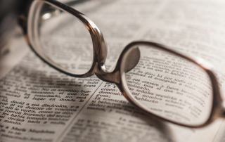 reading glasses on open Bible