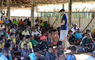 missionary teaching a group of people