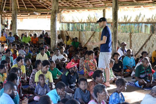 missionary teaching a group of people