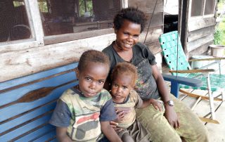 Moi woman with kids on a swinging bench