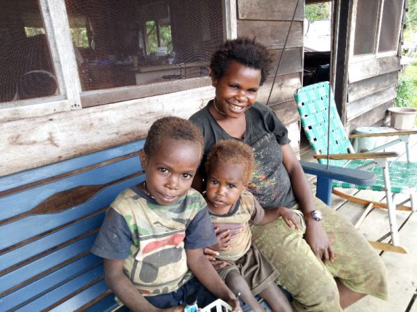 Moi woman with kids on a swinging bench