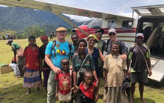 missionaries and friends standing by an airplane