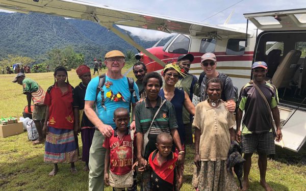 missionaries and friends standing by an airplane