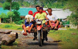 Filipino motorcycle taxi with 3 passangers