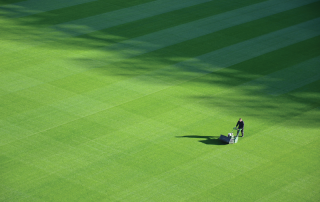 aerial view of a man mowing a large lawn