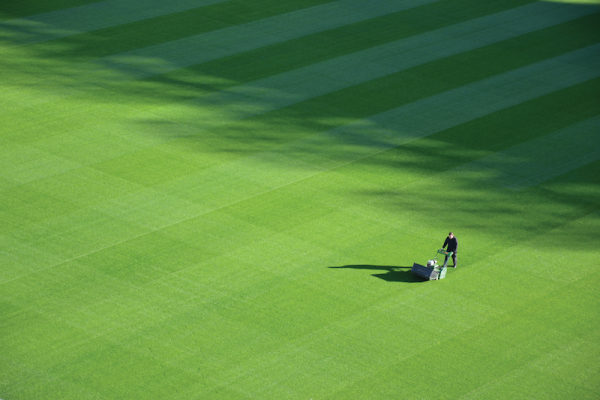 aerial view of a man mowing a large lawn